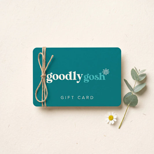 Goodly Gosh gift card in teal with cream logo, tied with jute twine beside eucalyptus and a daisy